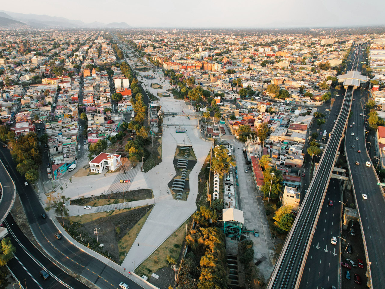 An aerial view showing Parque Lineal Gran Canal and a metro station in Mexico City